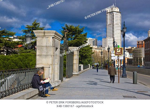 Tourist couple reading map along Calle de Bailen street with Torre de Madrid tower in background Madrid Spain Europe