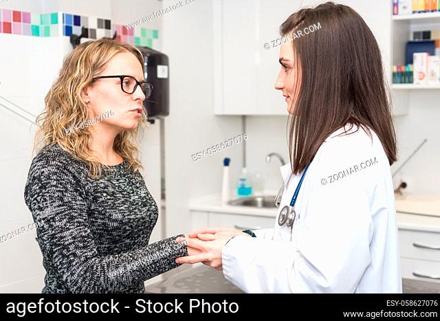 Doctor comforting a patient while discussing treatment . Medicine and health care concept