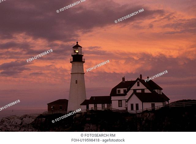 lighthouse, Cape Elizabeth, ME, Maine, Portland Headlight along the rocky coastline of the Atlantic Ocean at sunset