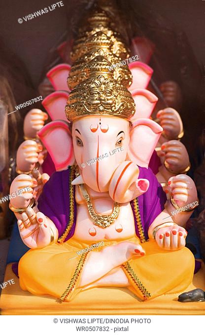 Idols of ganesh elephant headed god put one behind other for sale in Ganeshotsav , Pune , Maharashtra , India