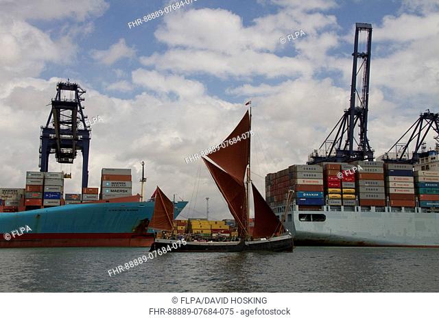 Old Thames sailing barge on River Orwell at the port of Felixstowe, the old and the new way of transporting goods