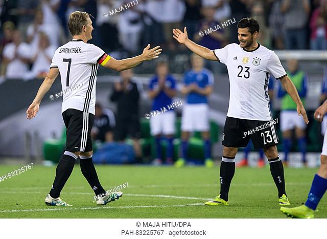 Germany's Bastian Schweinsteiger leaving the field and giving a high five to Kevin Volland during the international soccer match between Germany and Finland at...