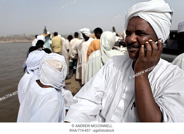 A Sudanese man talks on his mobile phone during a Nile ferry crossing to the town of Dongola, Sudan, Africa