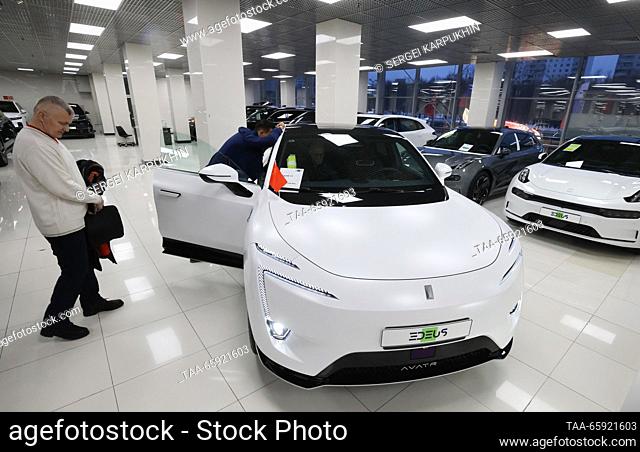 RUSSIA, MOSCOW - DECEMBER 19, 2023: People view a vehicle during the opening of the Moscow-Tianya international auto centre. Sergei Karpukhin/TASS