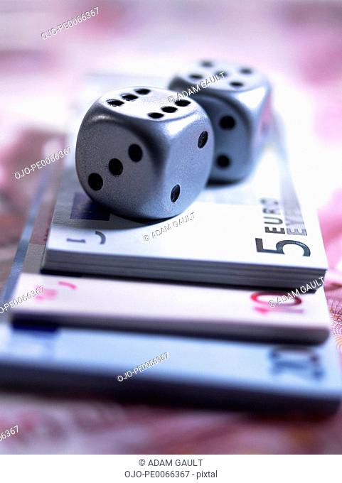 Close up of dice and euro notes