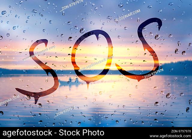 Rain on glass with SOS text