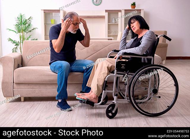 The old husband looking after disabled wife