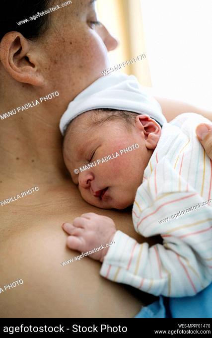 Woman holding newborn baby boy