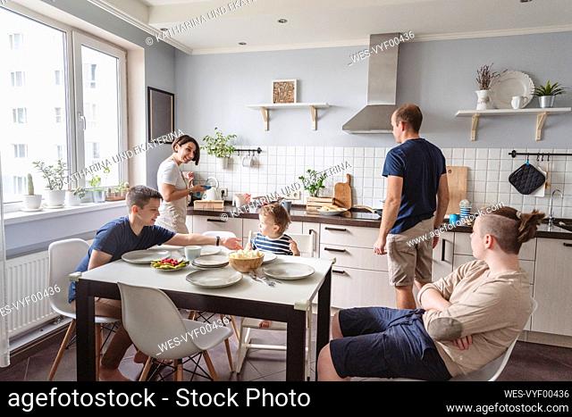 Happy family in kitchen at home