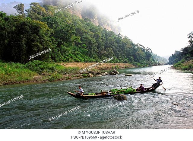 A boat carries bunch of banana through the Sangu river at Tindu Bandarban, Bangladesh November 2010
