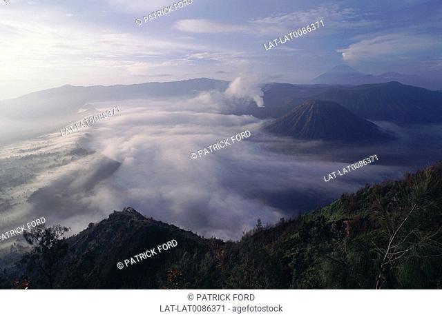 View across landscape. Gunung Bromo, Semeru active volcanos. Batok, blunt cone. Smoke plumes, cloud. Scenics & landscapesNational parkGeography - physical