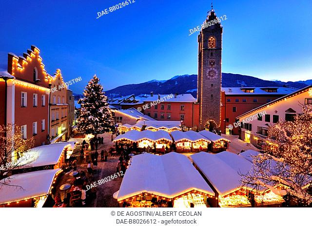 Winter view over the Christmas Market and the Civic Tower in Vipiteno, Trentino-Alto Adige, Italy