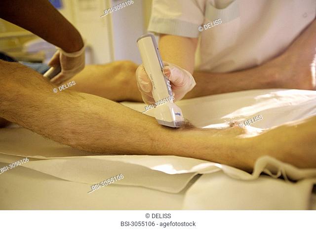 NURSE DISPENSING CARE<BR>Photo essay from hospital.<BR>Preoperative care. The nurses are shaving the area to be operated