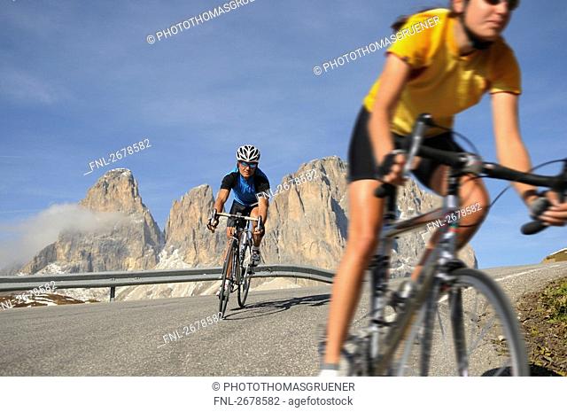Two mountain bikers cycling together, Dolomites, Italy