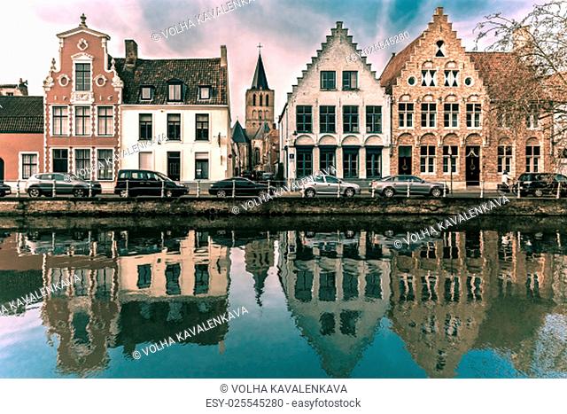 Scenic city view of Bruges canal with beautiful medieval houses, Belgium. Toning in cool tones