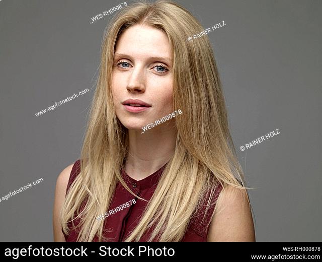 Portrait of daydreaming blond young woman