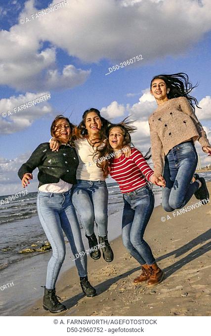 TEL AVIV ISRAEL Young Arab girls hamming it up for the photographer on the beach
