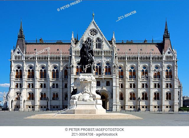 Hungarian Parliament building with the equestrian statue of the politician Gyala Andrassy on the bank of the river Danube in Budapest - Hungary