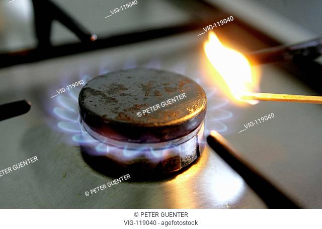 Torch lighting a gas cooker. - 06/09/2005