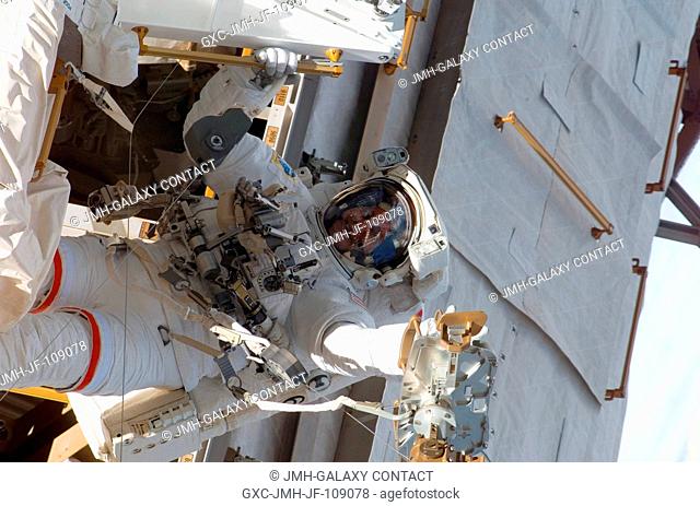 Astronaut Rick Linnehan, STS-123 mission specialist, participates in the mission's first scheduled session of extravehicular activity (EVA) as construction and...
