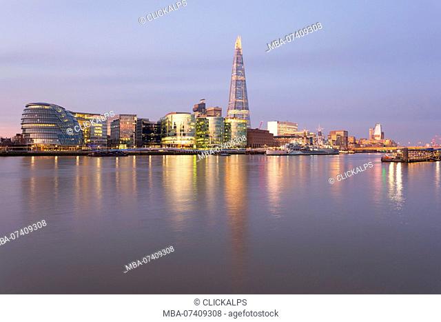 Southwark area with City Hall and Shard reflected in river Thames at dawn, London, Great Britain, UK