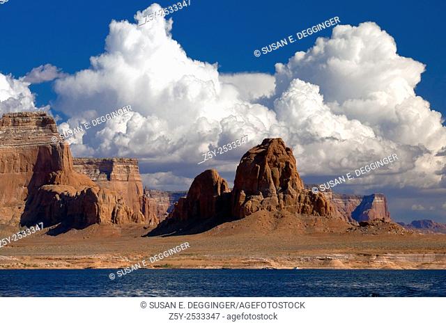 Red rock buttes and clouds on the shores of Lake Powell, Utah