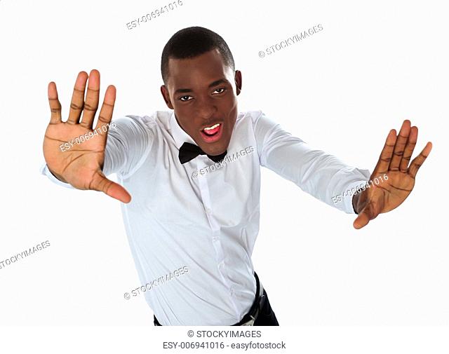Happy stylish black man stretching to camera against white background