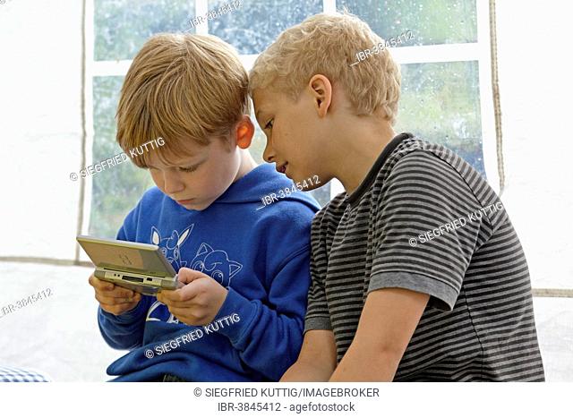 Two boys playing Nintendo