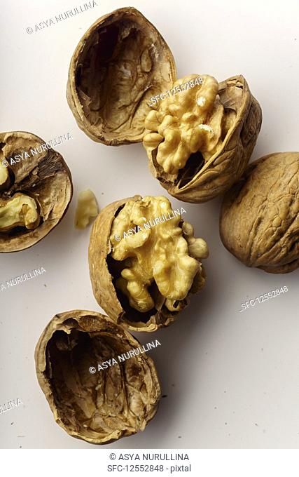 Raw walnuts with cracked nutshells