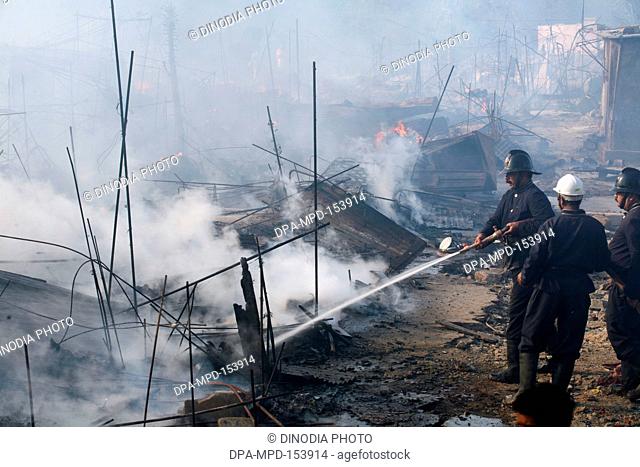 Firemen trying to douse off the fire which broke out at the Mhada colony situated at Versova ; Andheri ; Bombay now Mumbai ; Maharashtra ; India
