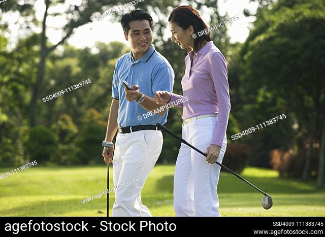 Chinese couple playing golf
