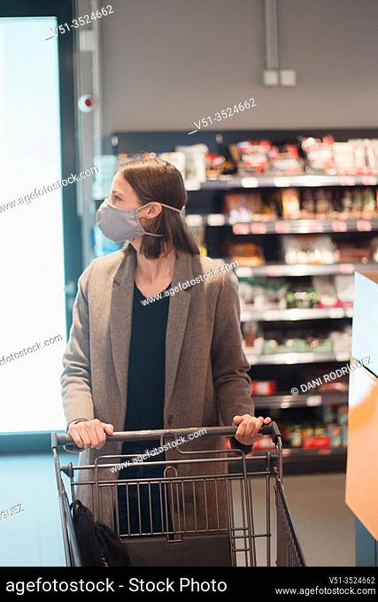Woman with mask in supermarket