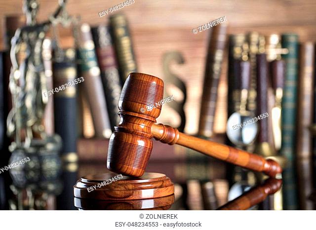 Judge’s gavel and books on wooden background. Place for typography