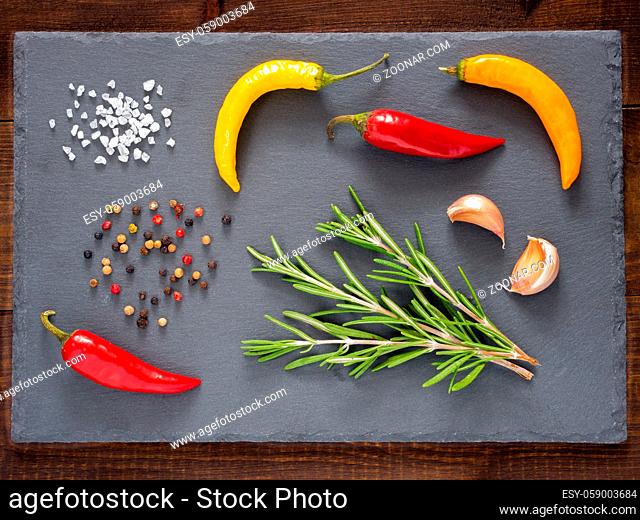 Herbs and spices over slate background. Top view or flat lay. Food background