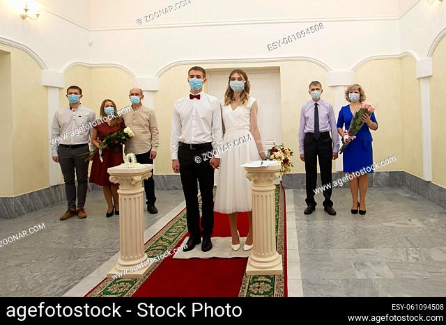 20 11 2020. Belarus, the city of Gomil. Marriage. Bride and groom wearing medical masks. Getting married during the coronavirus pandemic