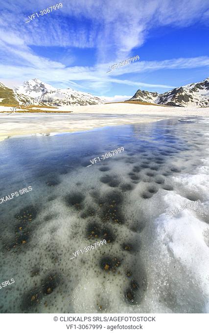 Ice melting at Lake Andossi during spring thaw, Chiavenna Valley, Spluga Valley, Sondrio province, Valtellina, Lombardy, Italy
