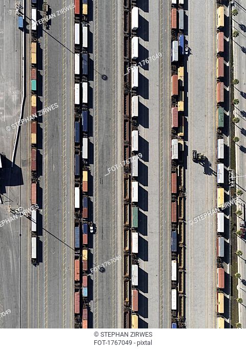 Aerial view trains in sunny shunting yard, Los Angeles, California, USA