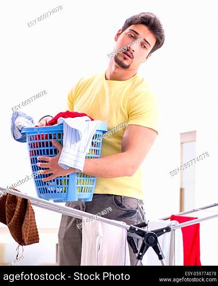 The handsome man husband doing laundering at home
