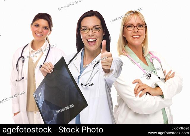 Three mixed-race female doctors or nurses with thumbs up holding x-ray isolated on white