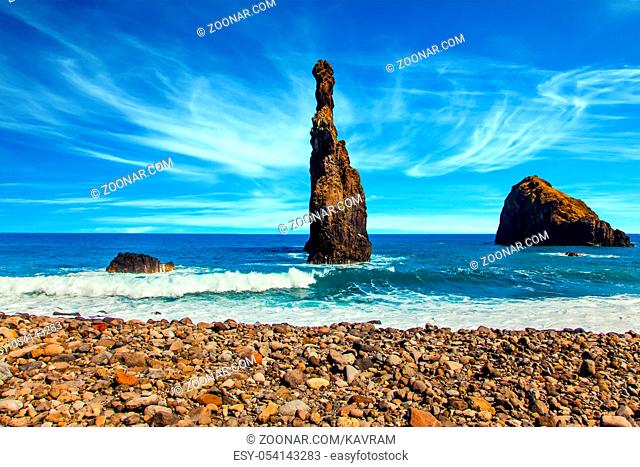 Volcanic fabulous island of Madeira in the Atlantic. Three huge scenic rocks near the pebble beach. Concept of exotic and ecological tourism