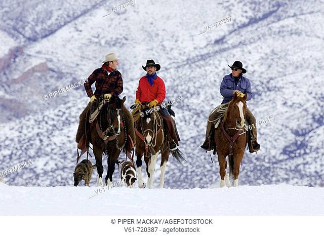 Cowboys out for a ride during winter in Shell, Whyoming, Usa
