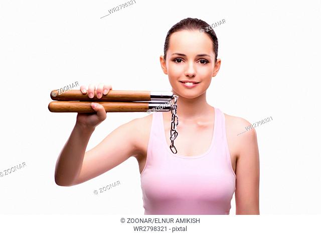 Young woman with nunchucks isolated on white