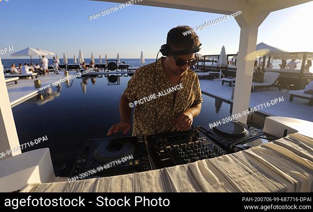 23 June 2020, Spain, Palma: Dj Guri performs at the Bar Purobeach in Cala Estancia on the beach Playa de Palma. Photo: Clara Margais/dpa