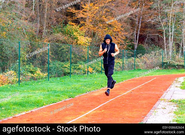 Young man jogging in the morning outdoor on the running race track