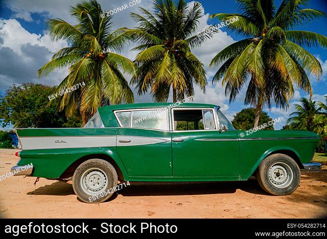 TRINIDAD, CUBA - DECEMBER 11, 2014: Old classic American car park on beach of Trinidad, CUBA. Old American cars are iconic sight of Cuba street