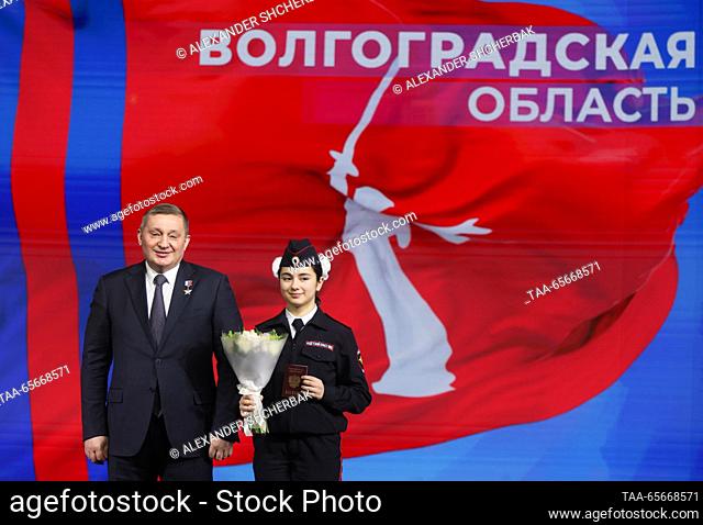 RUSSIA, MOSCOW - DECEMBER 12, 2023: Volgograd Region Governor Andrei Bocharov (L) poses for a photograph with a cadet at the opening of Volgograd Region Day...