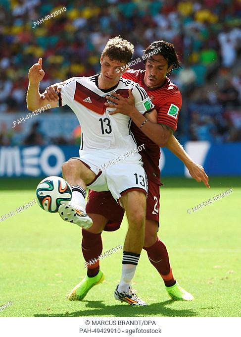 Germany's Thomas Mueller (L) in action against Portugal's Bruno Alves during the FIFA World Cup 2014 group G preliminary round match between Germany and...