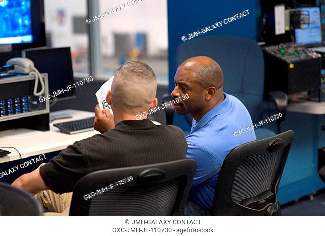 Astronauts Randy Bresnik (left) and Leland Melvin, STS-129 mission specialists, participate in a training session in the simulation control area in the Neutral...