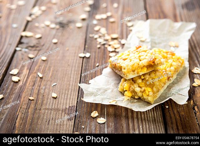 Cereal bar on paper on wooden table