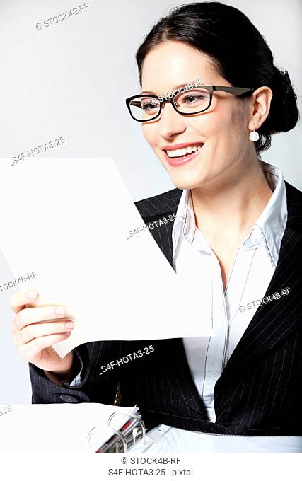 Smiling businesswoman reading document